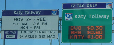 Photo of the Katy Tollway usage and hours of operation sign, with the Katy TollwayEZTag Only sign showing the current prices to travel to three locations along the tollway.