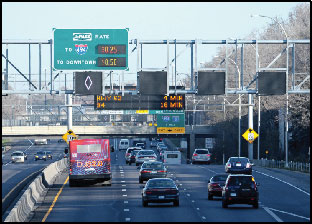 Photo of traffic passing under a sign gantry on the I-35W MnPASS facility.
