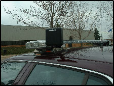 Photo showing the technology associated with the MnPASS I-394 HOT lanes.  The device attached to the vehicle's roof-mounted light bar.