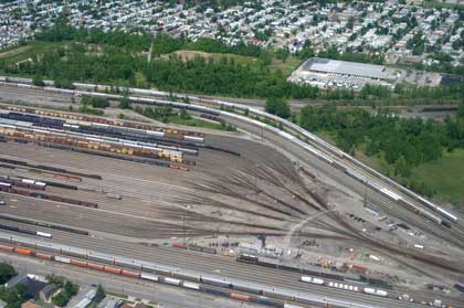 Figure 2.2 is an aerial photograph showing a wooded area separating a large rail yard from a residential area.