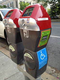 Photo of red-top parking meters for free disabled parking.