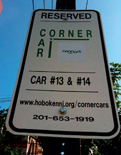 Photo of a reserved parking sign for a shared-use corner car.