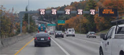 Photo.  Example of active traffic management performed on Seattle's I-5, northbound using dynamic speed limits by lane.