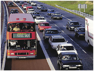 Transit bus using a shoulder lane to avoid rush-hour congested traffic.
