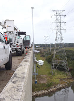 Photo of a wind speed sensor installed on the side of a bridge.