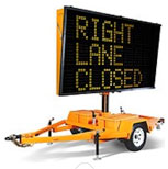 Photo of a towable variable message sign that reads, Right lane closed. 