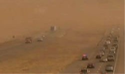 Photo of Interstate Ten during a dust storm. Visibility is so reduced that the far lanes are barely visible.