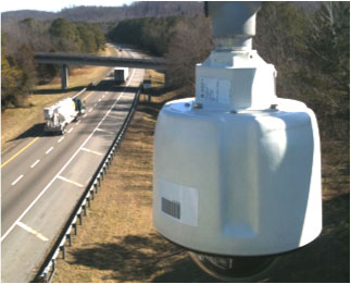Figure TN-2 is a photo of a CCTV camera suspended above a highway.