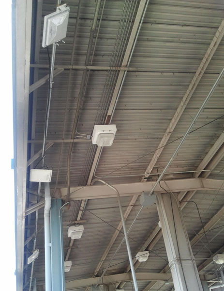 Figure 32. Photo. Completed installation of RFID equipment at CBP primary booth at BOTA. This photo shows installed radio frequency identification (RFID) antennae and readers on the canopy of the Customs and Border Protection inspection booth at the Bridge of the Americas.