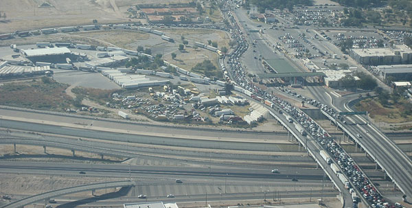 Figure 7. Image. Bridge of the Americas port of entry in El Paso-Ciudad Juárez region. This photo shows an aerial view of the Bridge of the Americas port of entry, looking south across the Rio Grande River from El Paso, Texas. Passenger vehicles and tractor-trailers are in their respective queues.