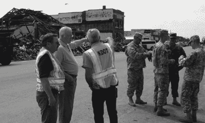 Picture of Kansas Department of transportation personnel and National Guard personnel surveying the damage caused by a tornado.