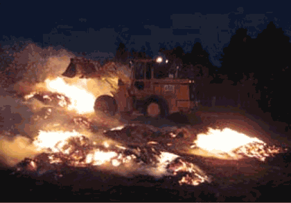 Picture of a piece of heavy equipment being used to fight a wildfire.