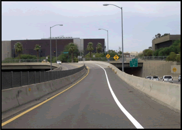 A photograph of a single lane of connector interstate separated by barriers.