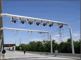 A photograph of an overhead truss with cameras mounted over the traveled way used in enforcement activities.