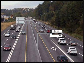 A photograph showing the left lane of an interstate with a double white stripe lane marking changing to a dashed white stripe where merging is allowed.