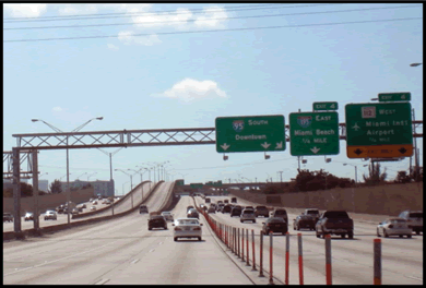 A photograph of an interstate section with HOV lanes and a direct connector ramp.