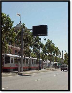 Photo - Picture of a light rail vehicle traveling along a vehicular roadway section.