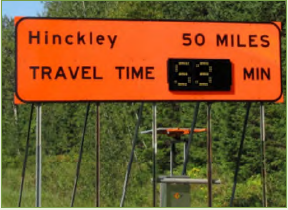 A roadway sign indicating the travel time for the location printed on the sign.