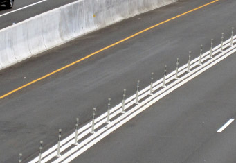 Photo of plastic post barriers set between a managed lane and a general purpose lane. The platic posts are approximately 4 feet tall, 5 inches wide and spaced 6 feet apart.