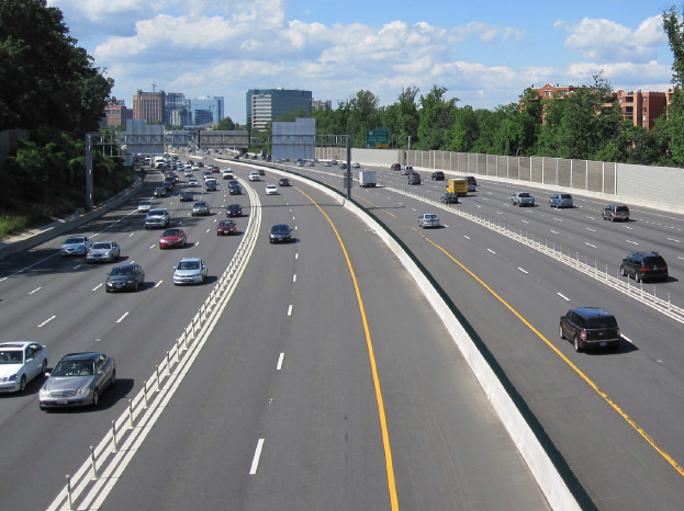 Photo taken from above freeway shows two sets of managed lanes situated adjacent to the general purpose lanes and within the freeway corridor.