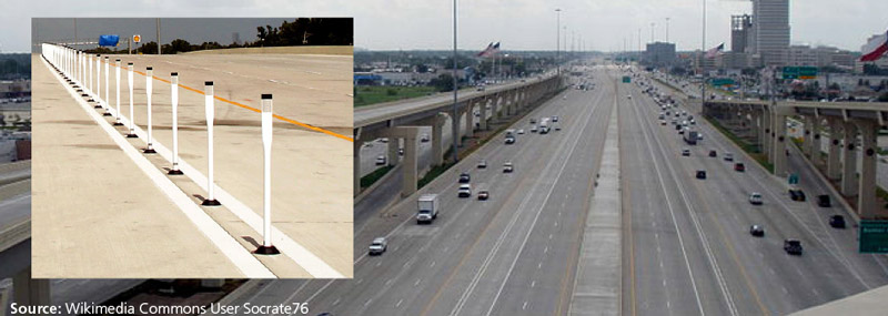 Photo of I-10 Katy Freeway with managed lanes with plastic post barriers and full shoulders on either side.