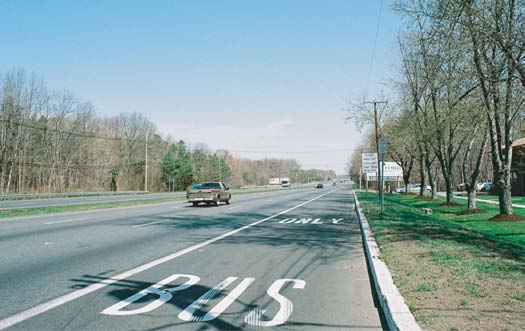Photo of white pavement markings used in New Jersey on the part-time shoulder lanes where BOS operations are used. The pavement reads “Bus Only”; the driver encounters the pavement marking for the word “Bus” first, followed by the pavement marking for “Only” downstream.