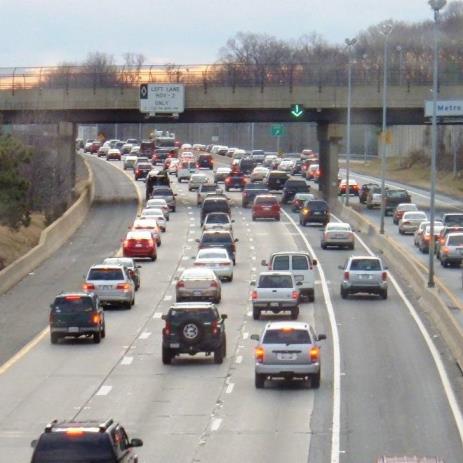 Photo of part-time shoulder operation in Northern Virginia where vehicles are traveling on the right-shoulder. A dynamic sign placed directly over the shoulder is displaying a steady downward-facing green arrow to indicate the shoulder is open for use.