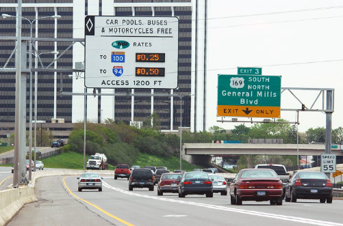 A sign on a gantry above an express lane depicts the cost for using the toll lanes to reach two destinations.