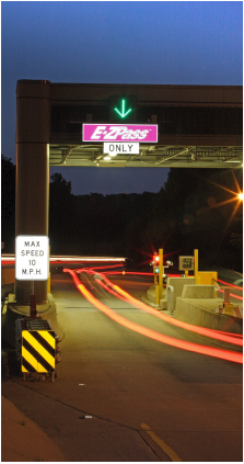 An entrance to the EZ-Pass express lanes in Virginia at night.