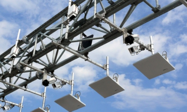 A series of video and transponder detection devices are mounted on the lower side of a gantry.