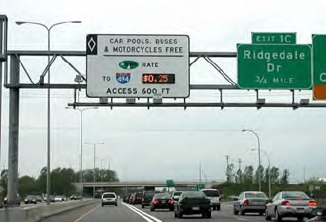 The image shows and HOT lane with an overhead guide sign with a dynamic panel displaying the price.