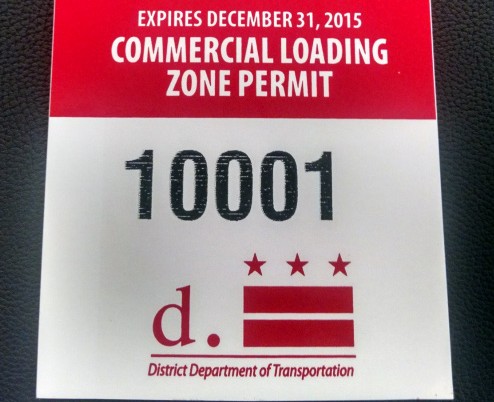 An example of a commercial loading zone permit with a permit number and the D.C. flag.