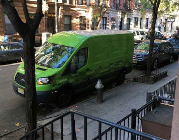 photo of a delivery van parked on a residential street in NYC