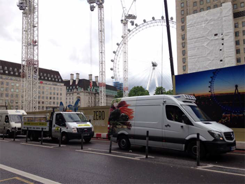 photo of three goods delivery and service vehicles on a London street with the London Eye cantilevered observation wheel in the background