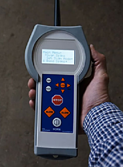 This photo shows a handheld device that operators can use to control an automated flagger assistance device remotely.