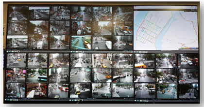 Photograph of the video wall in the New York City traffic management center that shows camera feeds from the intersections in the city that are part of the adaptive traffic signal control system.