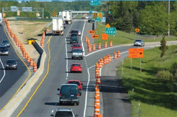 Figure 11. Photo of a line of cars traveling down a road in a work zone.