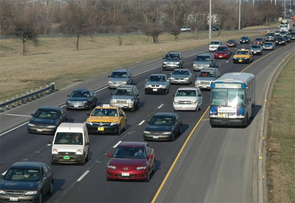 Figure 20. Photo of a highway with stopped traffic and a bus driving down the shoulder.