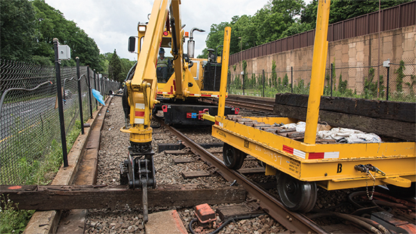 Figure 8. Photo of a pick and carry on a railroad track picking up a rail tie.