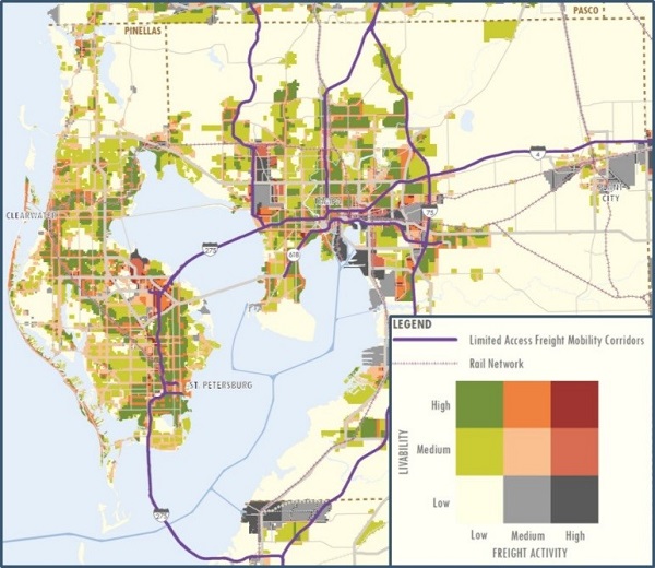 map of the Tampa, St. Petersburg, and Clearwater area of Florida. Limited access freight mobility corridors are highlighted. The map is color-coded to compare livability levels to freight activity levels with green being a high livability and low frieght activity color, light green being a medium livability and low freight activity color being predominate on the page. Darker colors such as dark red, dark pink and charcoal gray represent areas with high freight activity.