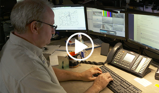 Pathfinder is a strategy to bring weather related agencies together to provide traveling public with consistent impact-base messages about road conditions. Video shows a man monitoring multiple computer screens, car turning with turning signal on, and road sign warning driver of slick spots.