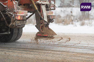 Photograph of a sand spreader in use identifying with the Road Weather Management CMF. (Credit: MakDill/Shutterstock)