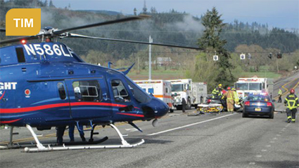 Photograph of an emergency crew, including a life flight helicopter, working an accident scene identifying with the Traffic Incident Management CMF. (Credit: https://www.oregon.gov/osp/programs/Pages/PSD.aspx#tim)
