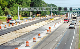Photo shows construction of the dynamic shoulder lane on the left of the road.