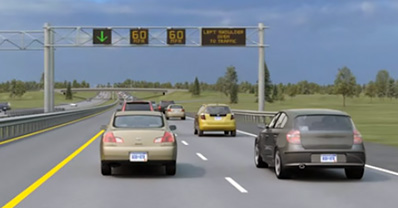 Photo rendition shows a variable message sign over the left shoulder of the road with a green arrow, indicating the dynamic shoulder lane is open.