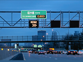 Photo shows dynamic shoulder lane closed, as indicated by closed message and merge message.