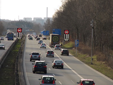 Photo shows cars in traffic using the right shoulder lane for travel in Denmark.