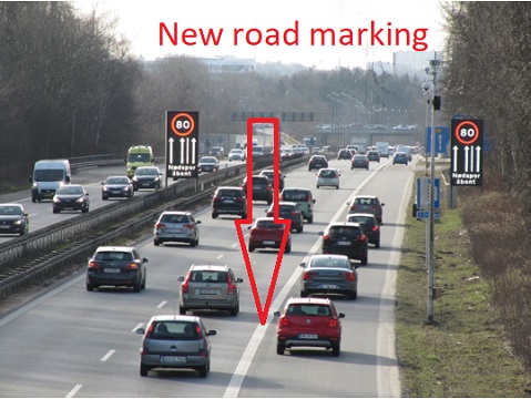 Photo shows dynamic shoulder lane open, as indicated by lighted signs on both sides of the road.