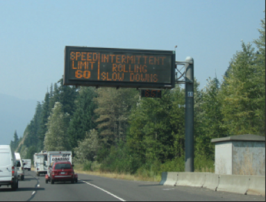 Overhead changeable message sign with rolling slowdown information.