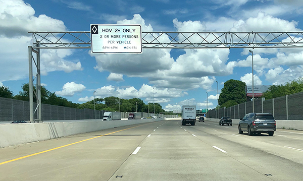 A freeway in Nashville, Tennessee with an overhead sign bridge.